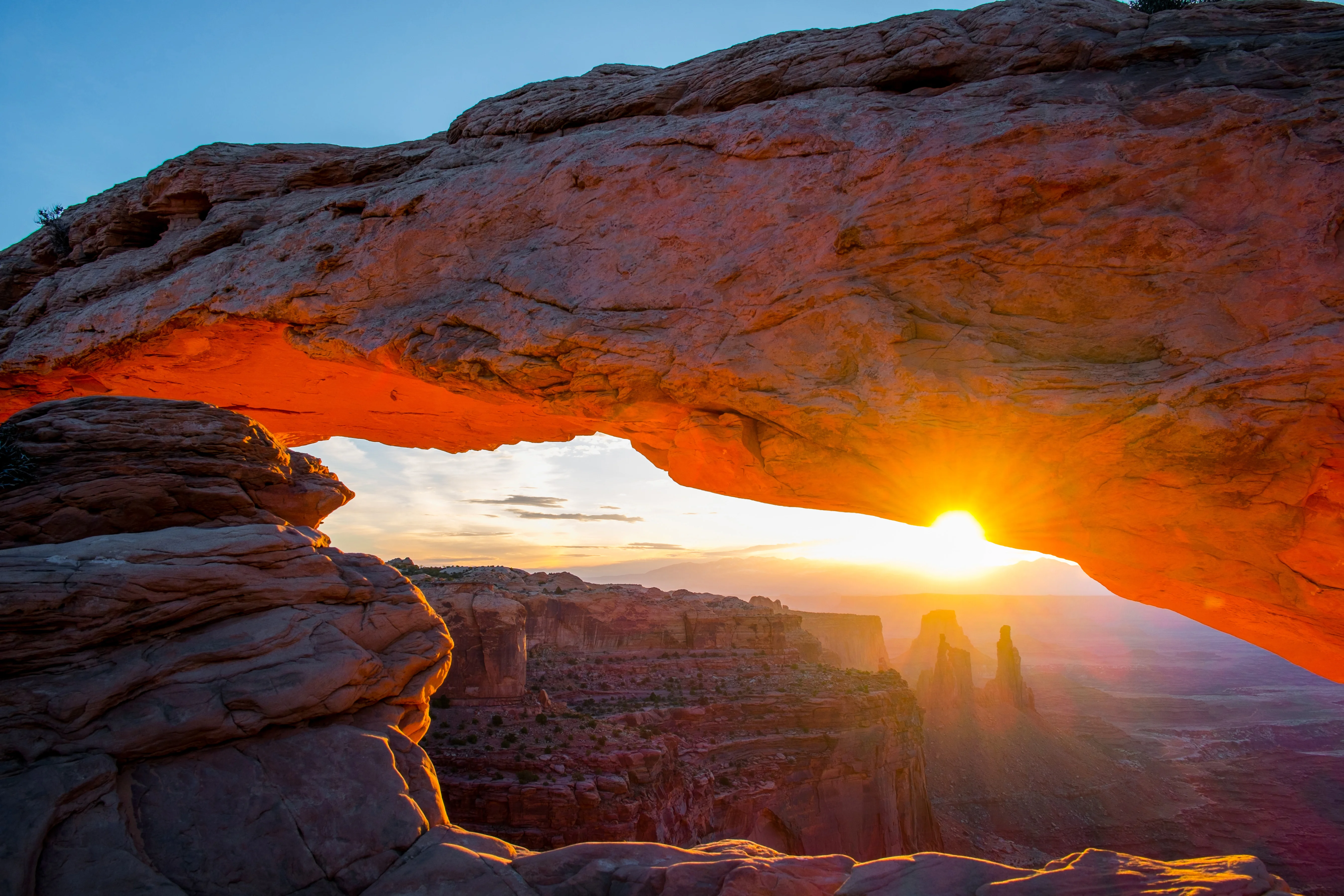 Sunrise glowing through Mesa Arch, Canyonlands National Park, Utah